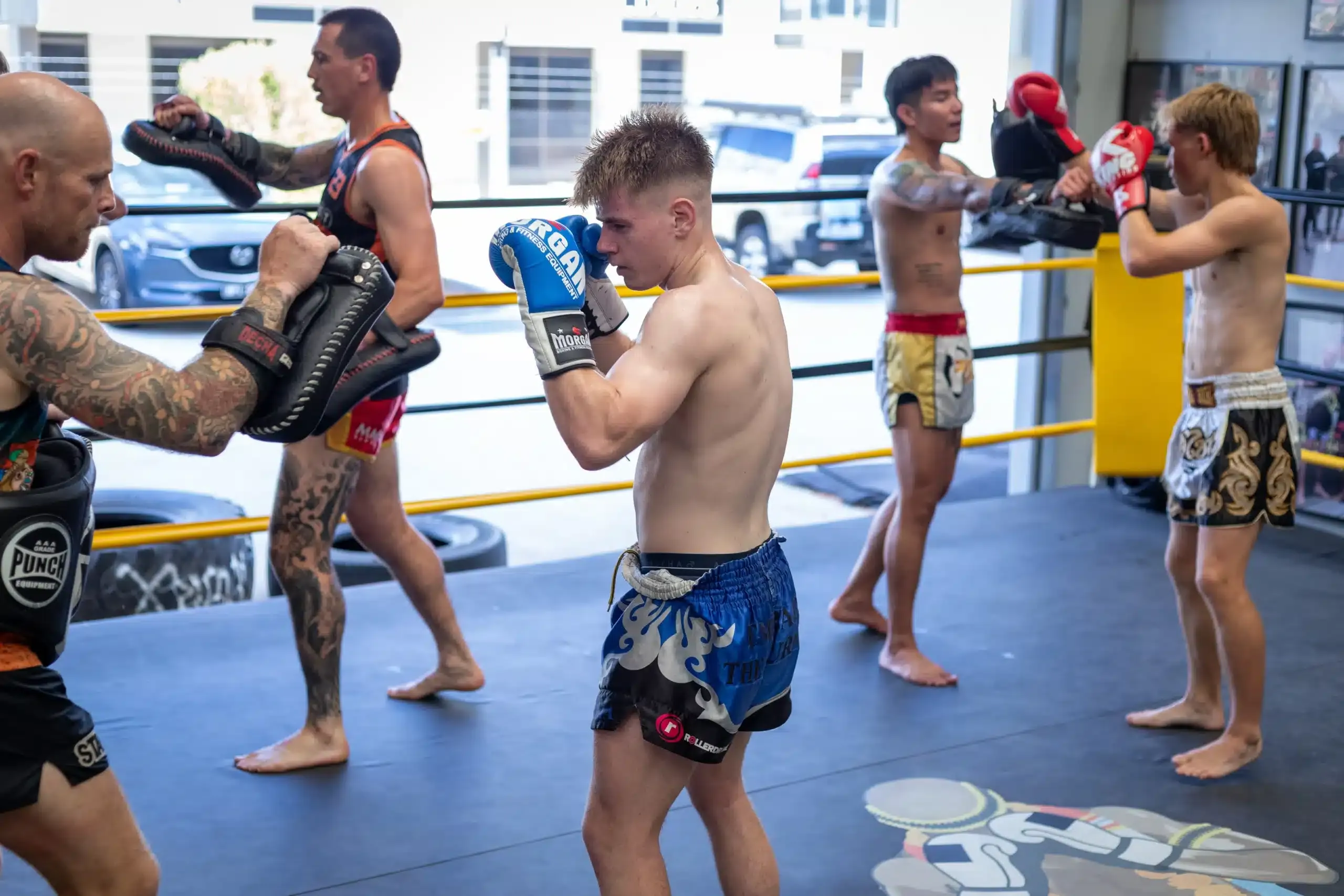 Members clinching during a Muay Thai session at Cool Heart